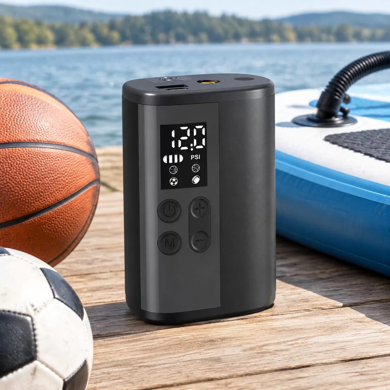 Slim black cylindrical pump connected to a basketball valve via a short black hose, demonstrating inflation on a white background