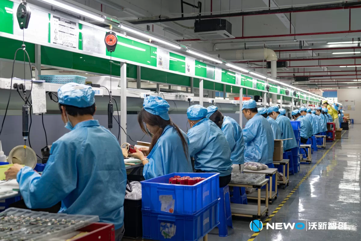 NEWO production team working at assembly stations
