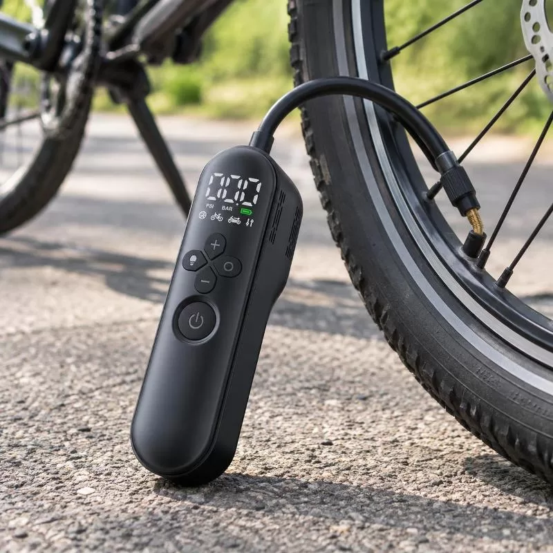Compact handheld electric bike pump shown with dimension callouts and included accessories