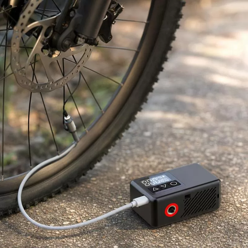 Compact BL01 bike pump with charging cable, Schrader adapter, French valve adapter, and ball needle