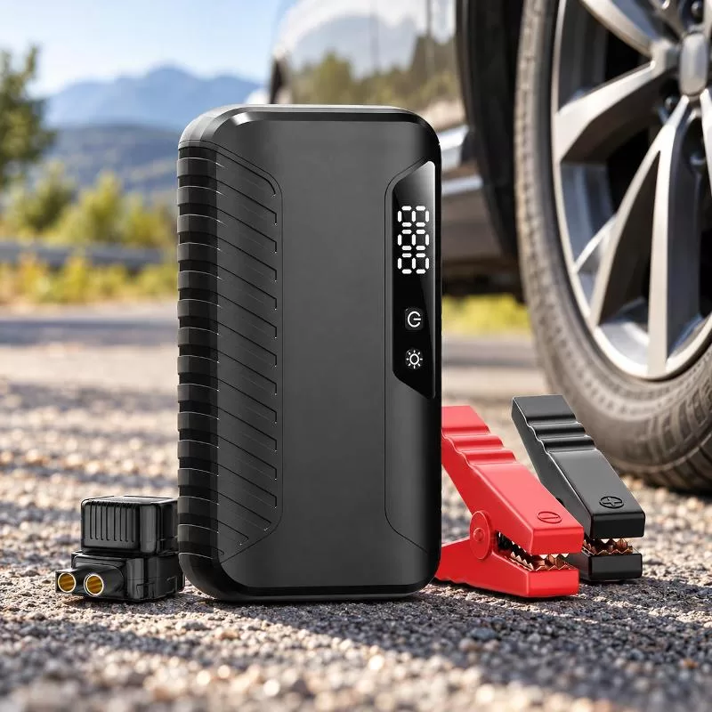 Jump starter connected to a car battery with red and black clamps attached