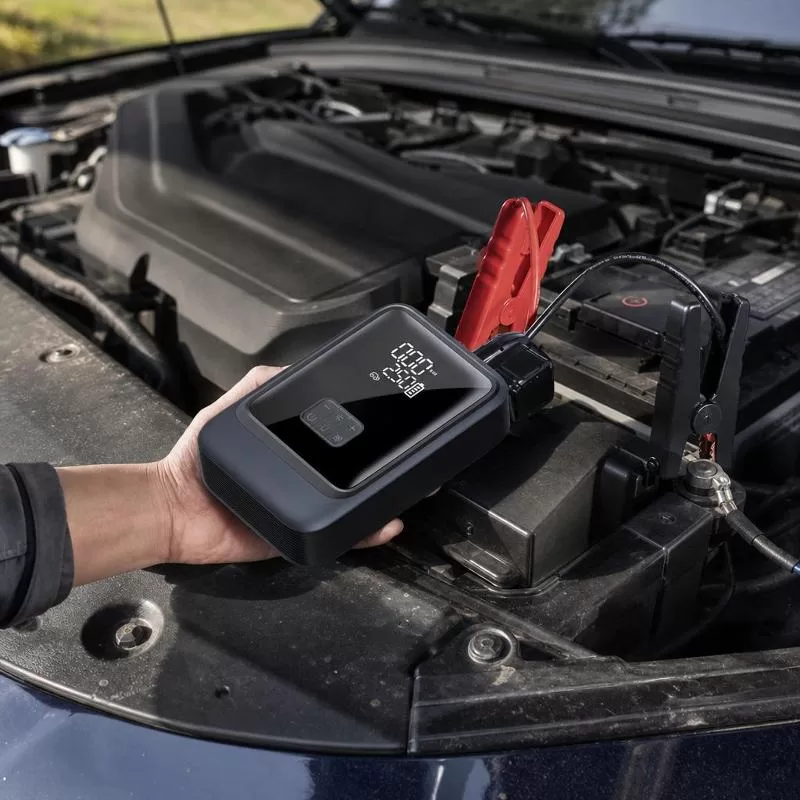 Jump starter unit shown beside a smartphone demonstrating power-bank charging