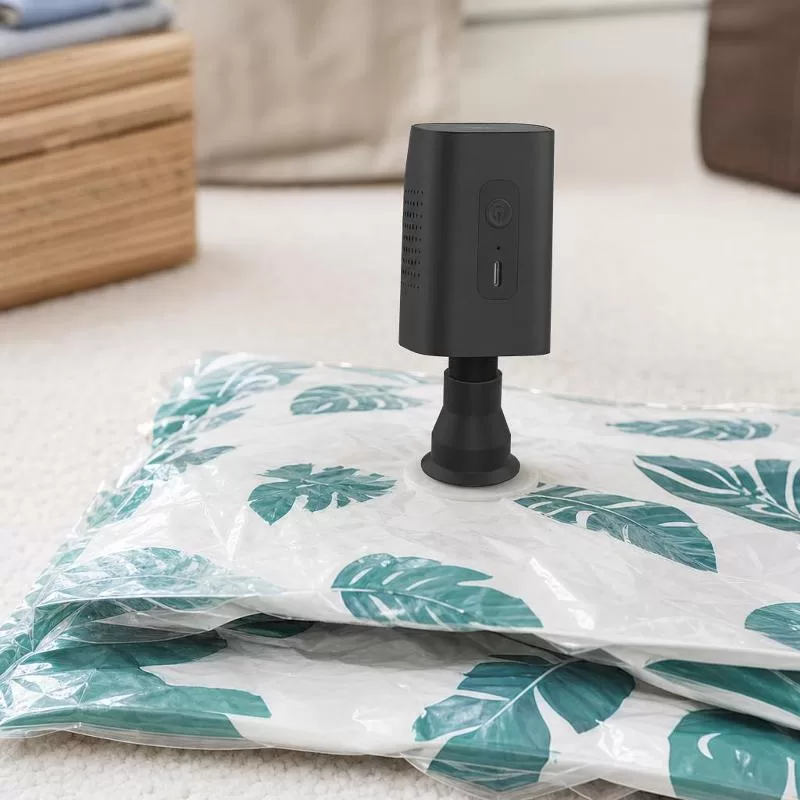 Pump compressing a vacuum storage bag with a wide nozzle attachment