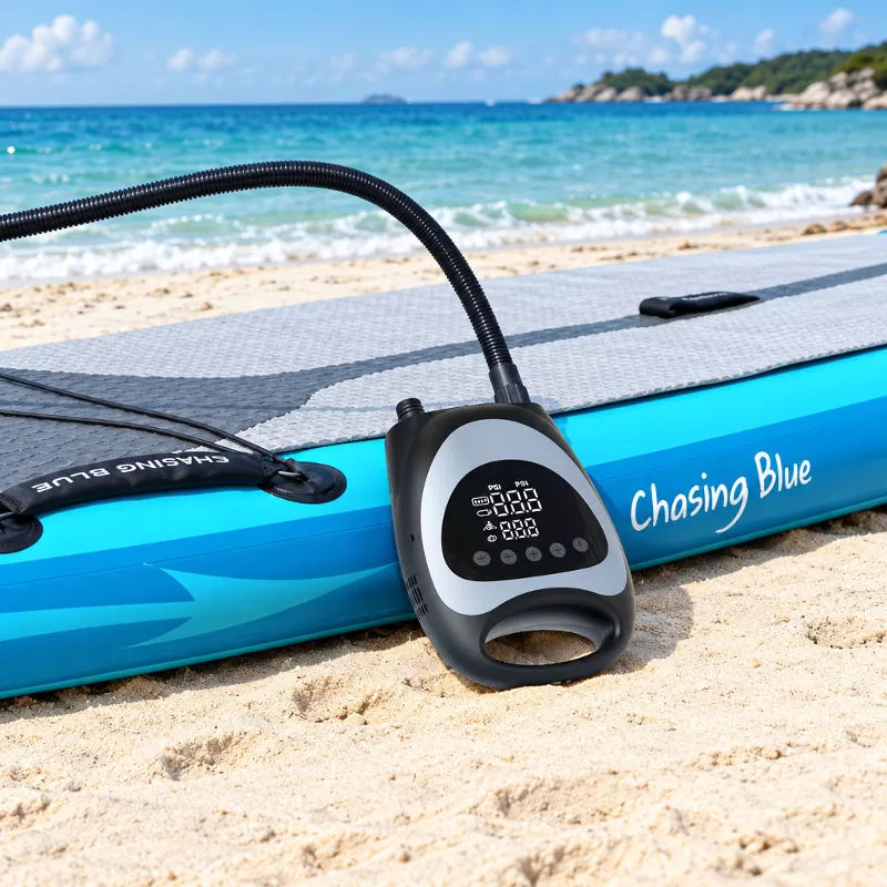 Cordless Electric SUP Air Pump with 12V Cable and Nozzle Adapters Overhead view of a black and gray oval-shaped electric SUP pump with attached flexible hose, 12V vehicle cable, nozzle adapters, and storage pouch